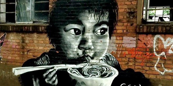 Graffiti of Chinese boy eating noodles