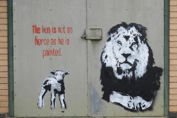Graffiti art of lion with lamb